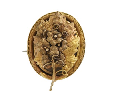 Lot 225 - An unusual Victorian gold leaf design locket brooch.