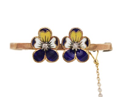 Lot 229 - A gold and enamel old mine-cut diamond set bar brooch, applied with double pansy flower heads.