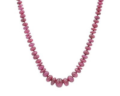 Lot 307 - A ruby graduated bead necklace, strung to a pair of 18k lobster claw clasps.