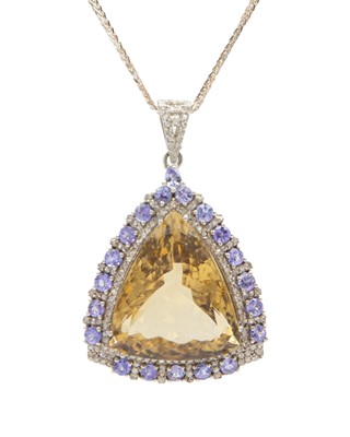 Lot 240 - A large pendant set with a triangle-cut citrine, tanzanites and diamonds, set in silver.