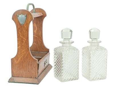 Lot 9 - An Edwardian oak two bottle tantalus.