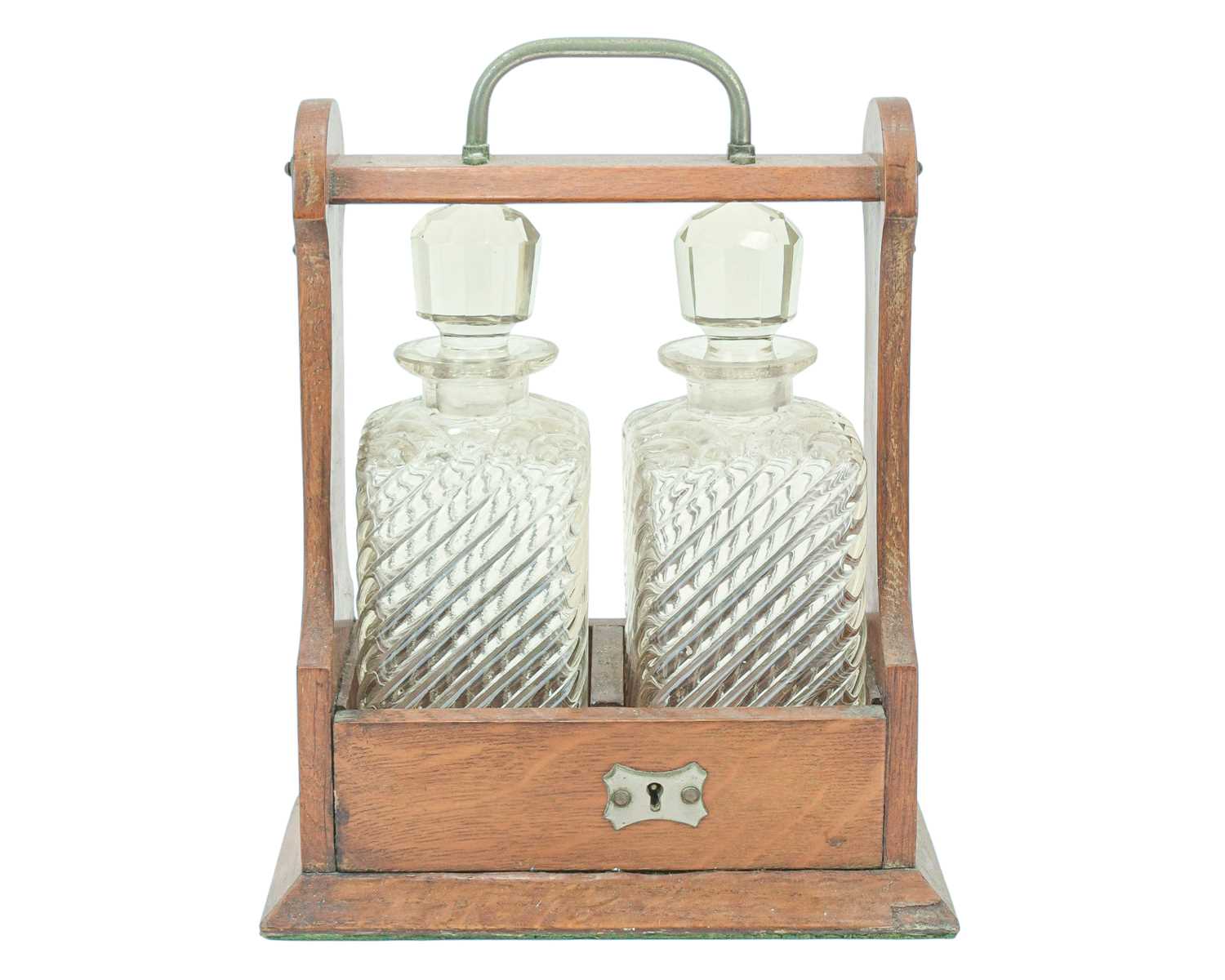 Lot 9 - An Edwardian oak two bottle tantalus.