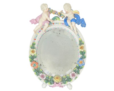 Lot 518 - A German porcelain framed oval mirror.