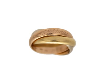 Lot 271 - MUST DE CARTIER - An 18k tr-colour gold 'Trinity' ring, with box and certificate.