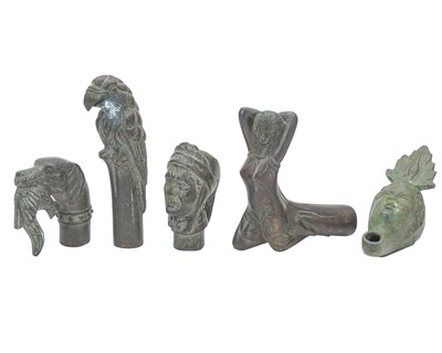 Lot 83 - Four bronze walking cane handles.