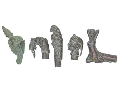 Lot 83 - Four bronze walking cane handles.
