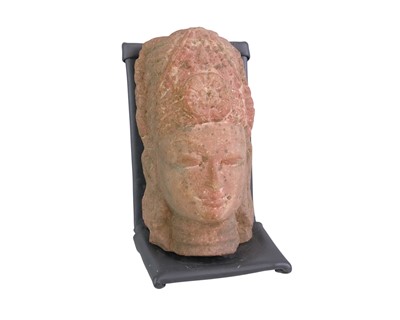 Lot 423 - A carved stone head of Vishnu.