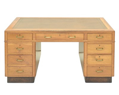 Lot 842 - A 1930s oak twin pedestal writing desk.