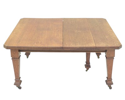 Lot 845 - An Edwardian oak extending dining table.