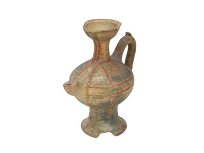 Lot 141 - A Near Eastern terracotta spouted jar.
