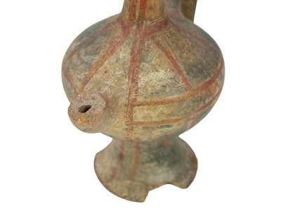Lot 141 - A Near Eastern terracotta spouted jar.