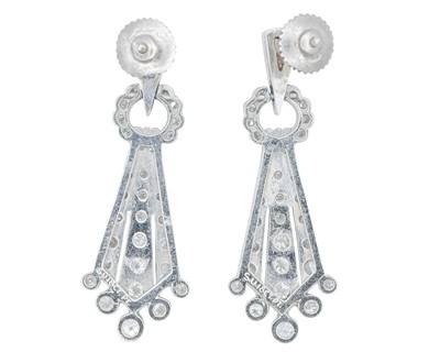 Lot A fine pair of Art Deco 18k and platinum diamond set drop pendant earrings.