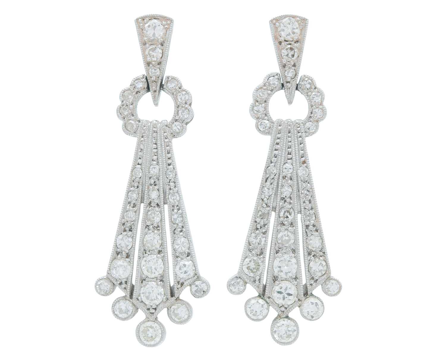 Lot A fine pair of Art Deco 18k and platinum diamond set drop pendant earrings.
