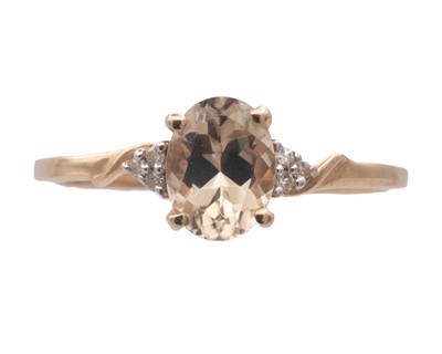 Lot 33 - A 9k diamond and oval Csarite ( Diaspore) set ring by Gemporia.