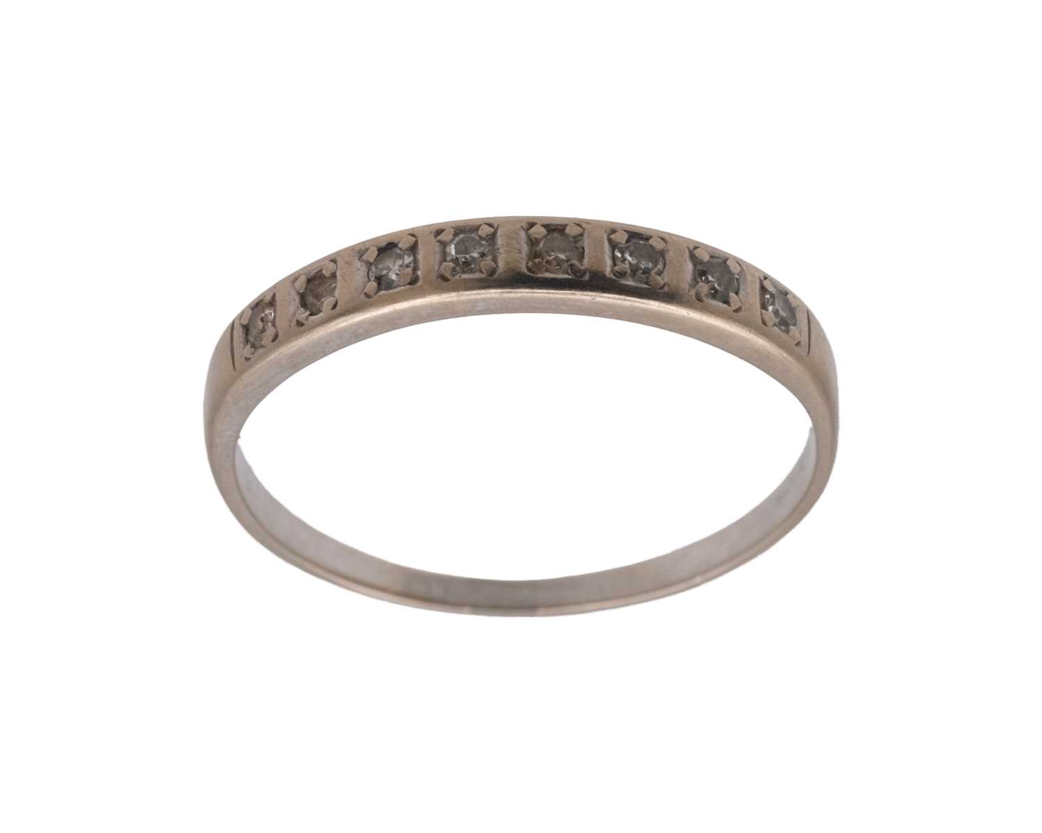 Lot 35 - A high-purity white gold diamond set half eternity ring.