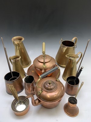 Lot 186 - A set of three graduated brass jugs, the...
