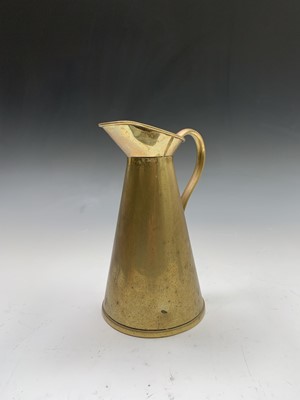 Lot 186 - A set of three graduated brass jugs, the...