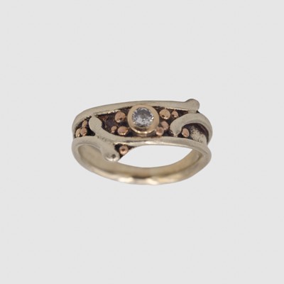 Lot LES GRIMSHAW - A 9k white and rose gold diamond set ring.