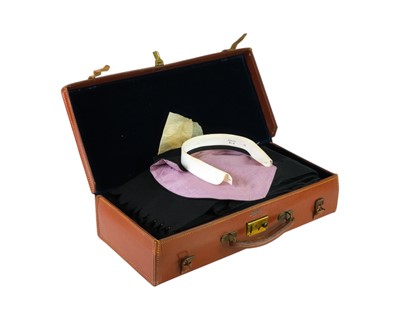 Lot 99 - A monogrammed tan leather case with contents of Masonic regalia and liturgical accessories.