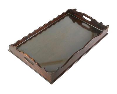 Lot 58 - A 19th Century mahogany tea tray with shaped and pierced sides.