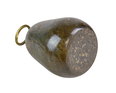 Lot 74 - A Cornish serpentine door stop with brass loop handle.