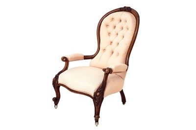 Lot 793 - A mid Victorian walnut framed ballon back open armchair.
