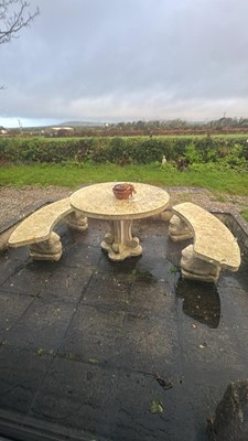 Lot 824 - A composite stone garden table, and two benches with winged lion supports