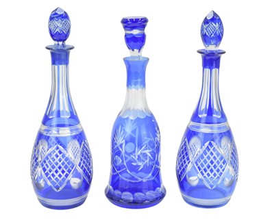 Lot 523 - A pair of Bohemian blue overlay glass decanters and stoppers.