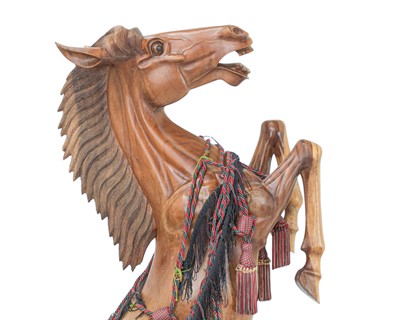 Lot 102 - A large carved hardwood figure of a rearing stallion.