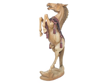 Lot 102 - A large carved hardwood figure of a rearing stallion.