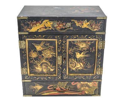 Lot 334 - A Japanese lacquered table cabinet with gilded decoration.