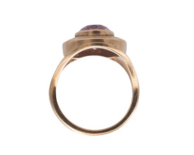 Lot 48 - A Modernist 9k oval cut amethyst set dress ring.