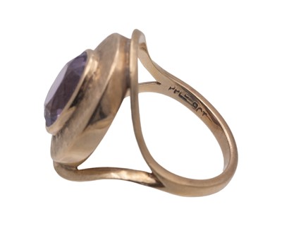 Lot 48 - A Modernist 9k oval cut amethyst set dress ring.