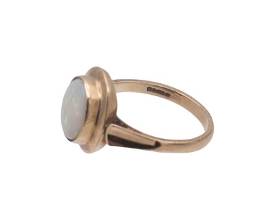 Lot 43 - A 9k hallmarked gold oval white opal set ring.