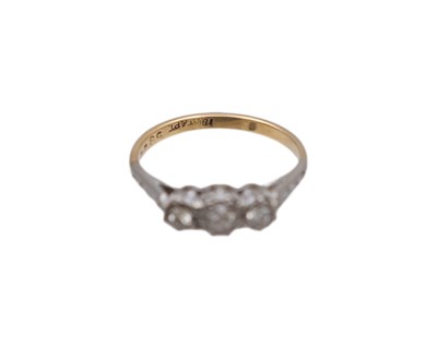 Lot 36 - An 18k and platinum diamond set three-stone ring.
