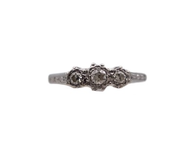 Lot 36 - An 18k and platinum diamond set three-stone ring.