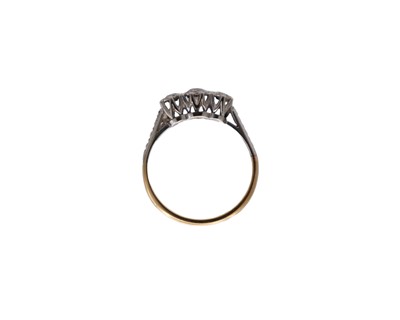 Lot 36 - An 18k and platinum diamond set three-stone ring.