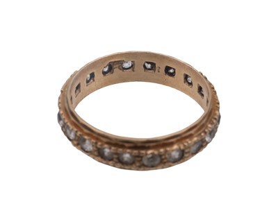 Lot 30 - A 9k band ring, and a 9k white spinel set eternity ring.