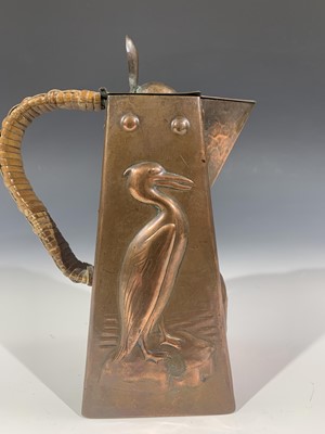 Lot 131 - A Newlyn copper hot water jug, repousse...