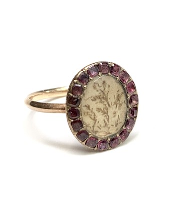 Lot 2357 - A Georgian gold ring with an amethyst framed...