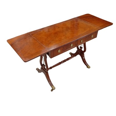 Lot 24 - A drop-leaf sofa table with claw caster feet....