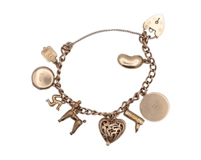 Lot 44 - A 9k charm bracelet with eight various 9k charms and padlock clasp.