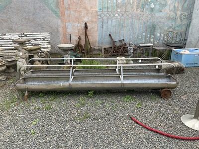 Lot 7 - A pair of galvanised metal sectional feeding...
