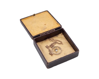 Lot 27 - A 9k rose gold spider pendant, set with rubies and pale blue paste, on a 9k neck chain.