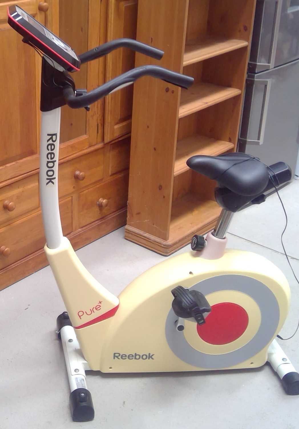 Lot 36 - A Reebok Pure+ Exercise Cycle. The Cycle and...