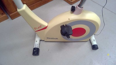 Lot 36 - A Reebok Pure+ Exercise Cycle. The Cycle and...