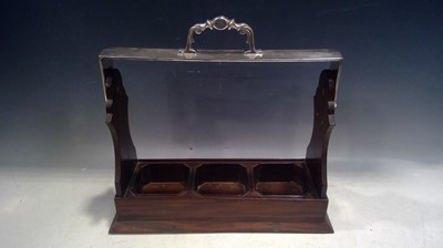 Lot 80 - A tantalus for three bottles. The Apertures...