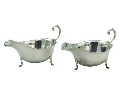 Lot 309 - A pair of silver sauce boats by Walker & Hall.