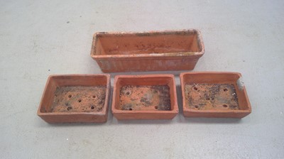 Lot 227 - A Terracotta Trough and Three Planters. The...