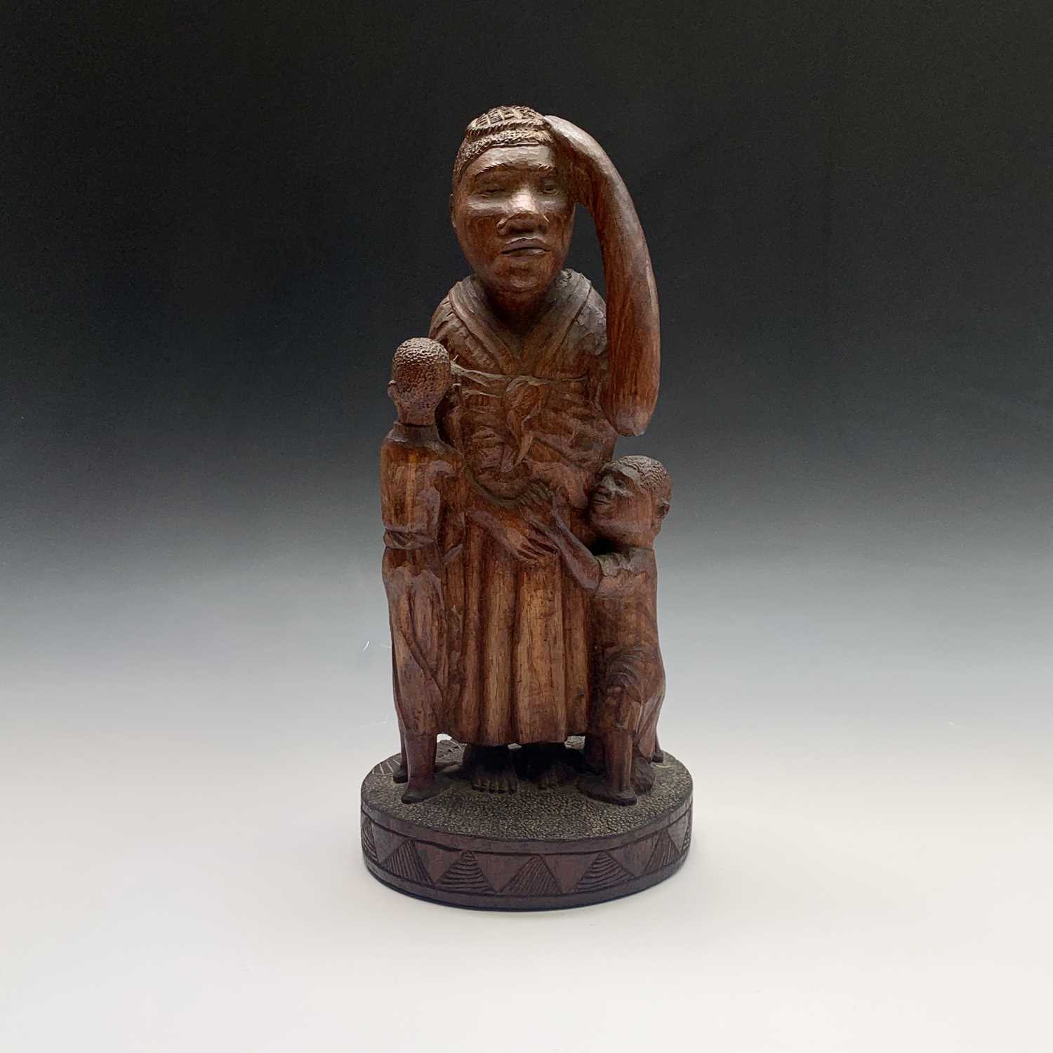Lot 126 - An African carved wood sculpture depicting a...